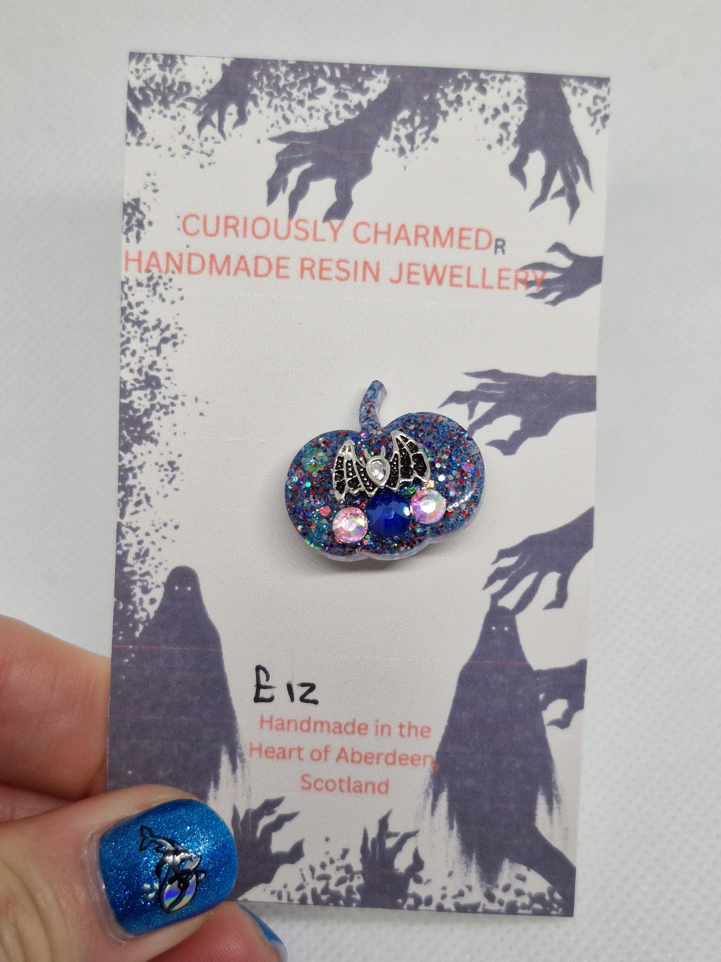 Small Blue Glitter Pumpkin Brooch with small bat charm